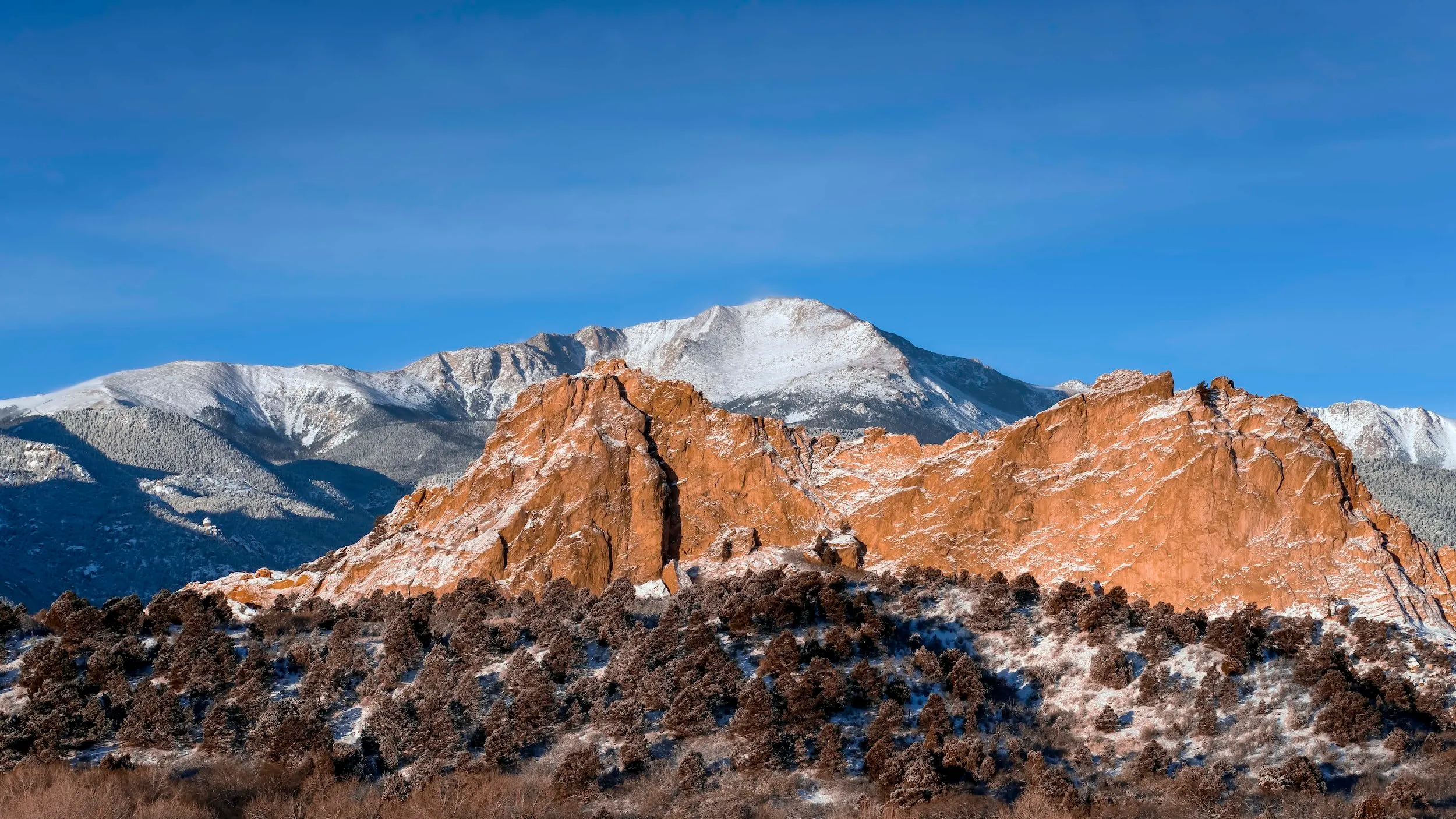 Pikes Peak rising behind the red rocks of Garden of the Gods, Colorado